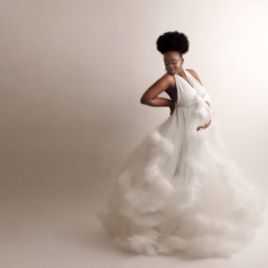 woman wearing white dress in a maternity session in york
