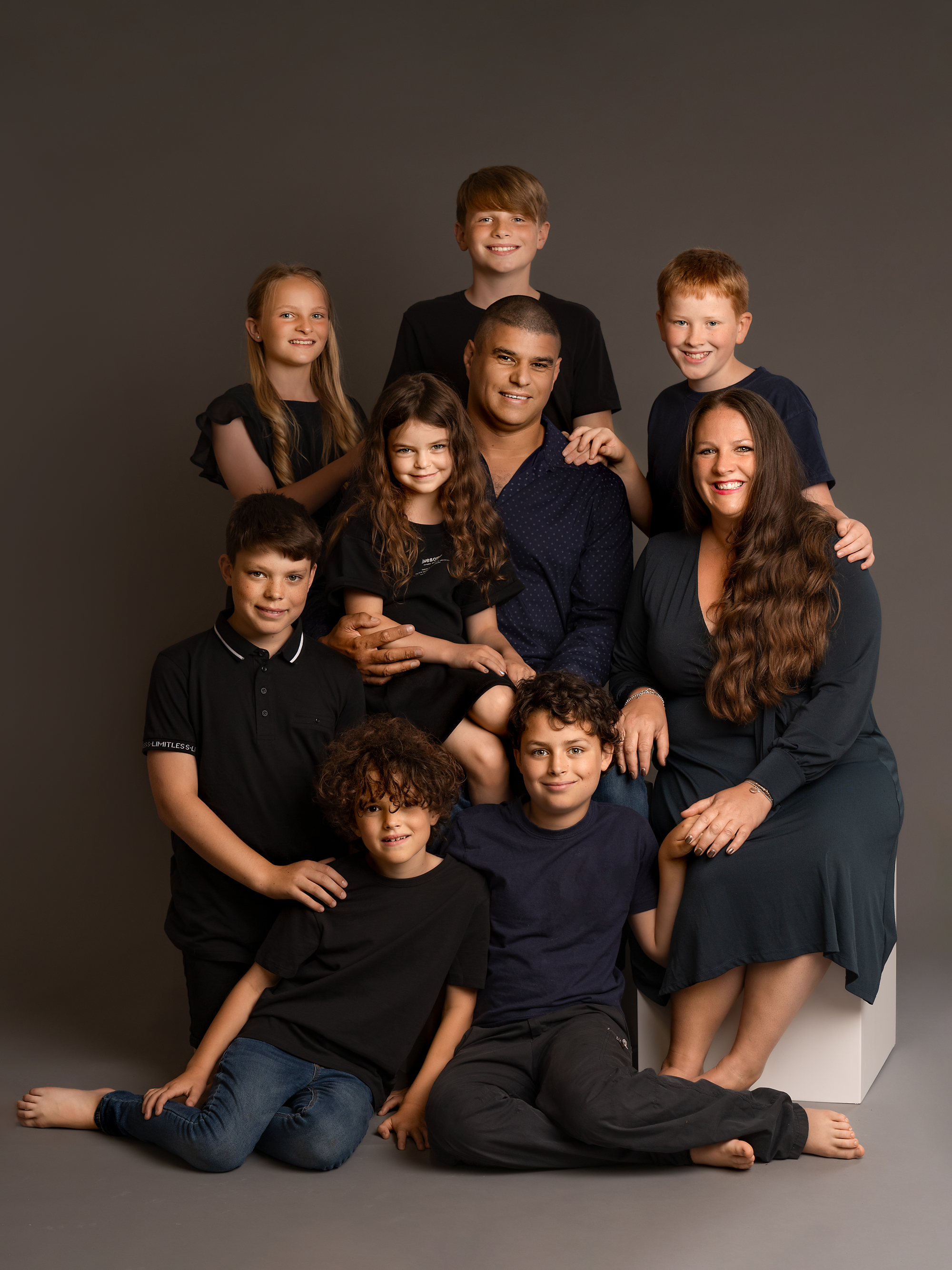 family of nine posing during a photo session in York