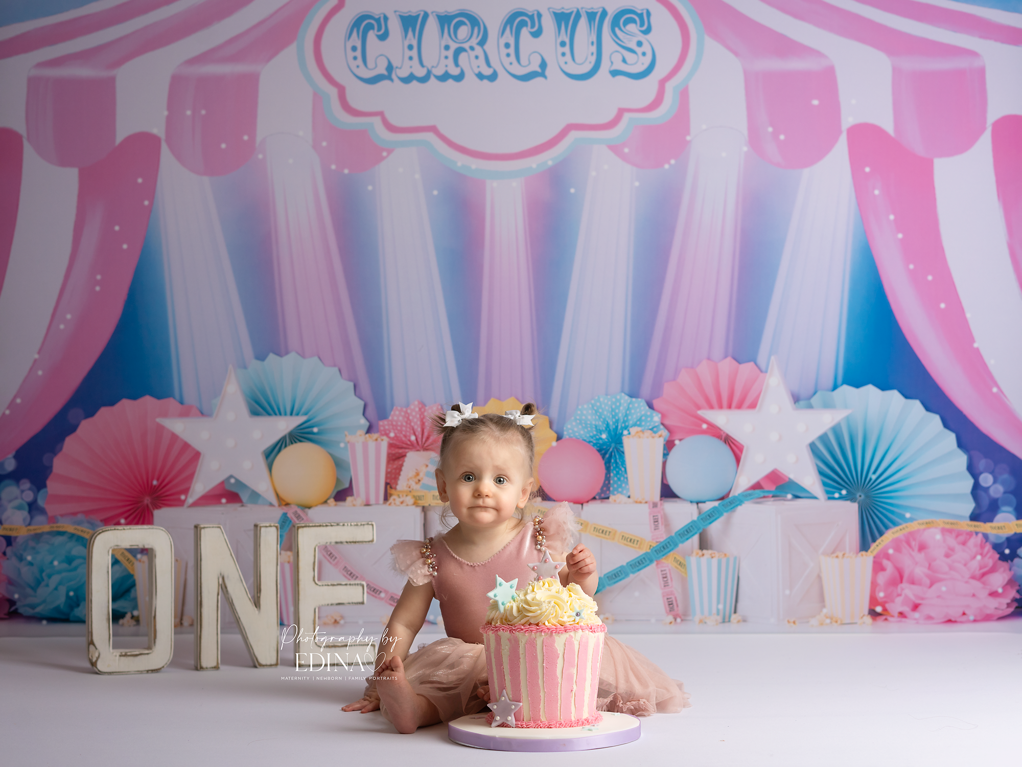 little girl posing for her first birthday shot in York during a cake smash and splash session